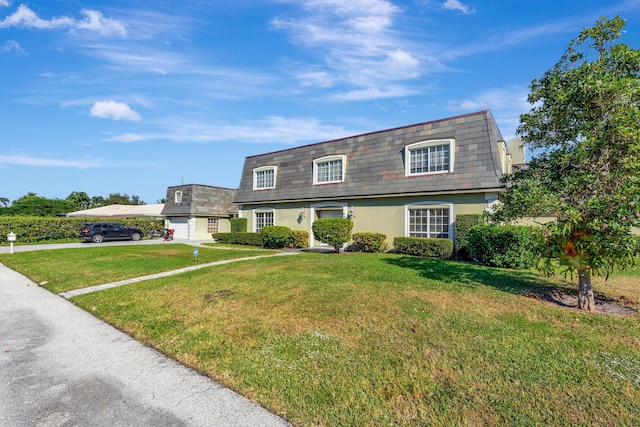 view of front of home with a garage and a front lawn