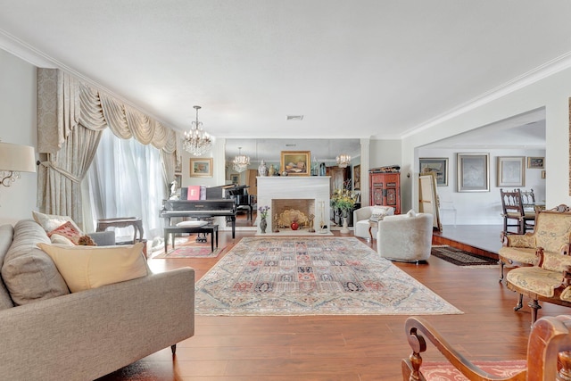 living room with wood-type flooring and ornamental molding