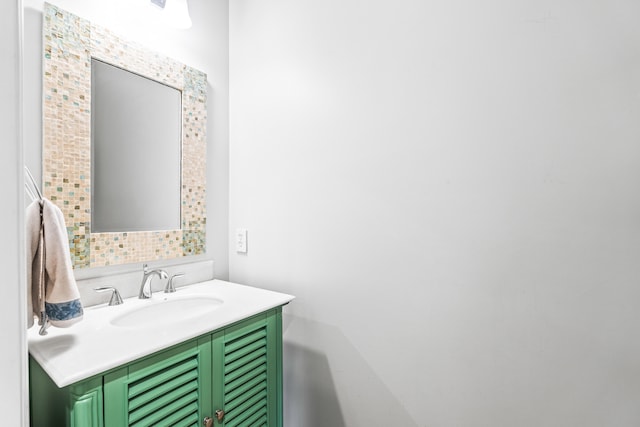 bathroom featuring vanity and tasteful backsplash