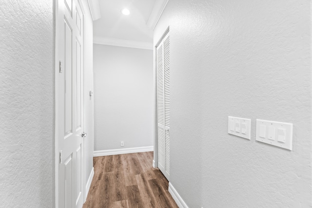 hall with dark hardwood / wood-style flooring and ornamental molding