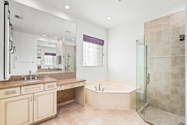 bathroom featuring tile patterned floors, vanity, and separate shower and tub