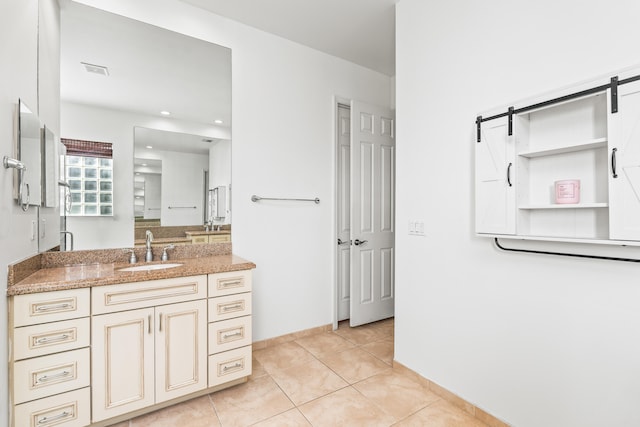 bathroom featuring tile patterned flooring and vanity