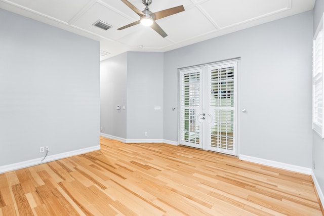 empty room with french doors, light hardwood / wood-style flooring, and ceiling fan