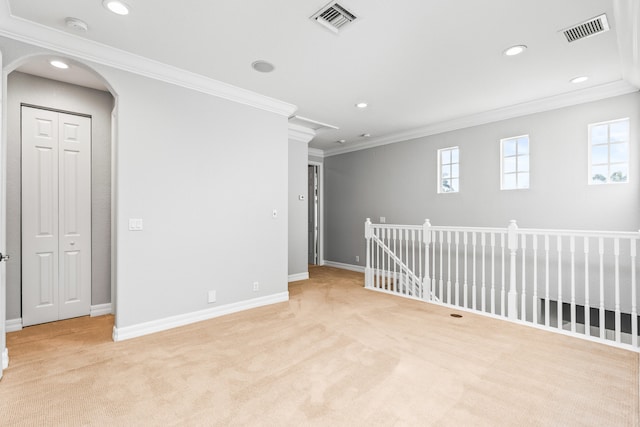 carpeted spare room with a healthy amount of sunlight and crown molding