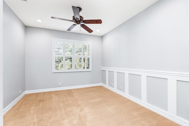 empty room featuring light carpet and ceiling fan