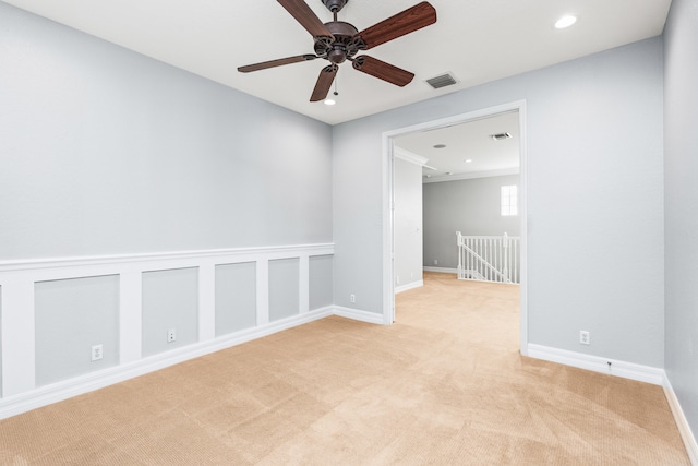 carpeted empty room featuring ceiling fan