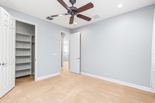 unfurnished bedroom with ceiling fan and light carpet