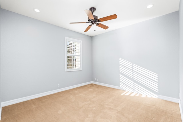 carpeted empty room featuring ceiling fan