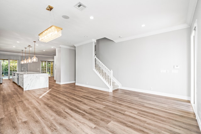 unfurnished living room with light hardwood / wood-style flooring and ornamental molding