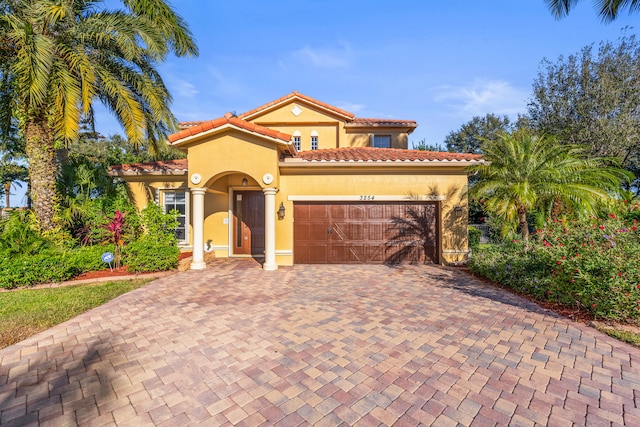 mediterranean / spanish house with a garage