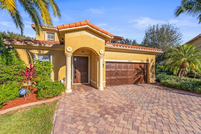 mediterranean / spanish house featuring a garage