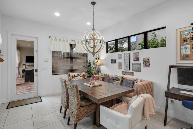 dining area featuring an inviting chandelier and light tile patterned floors