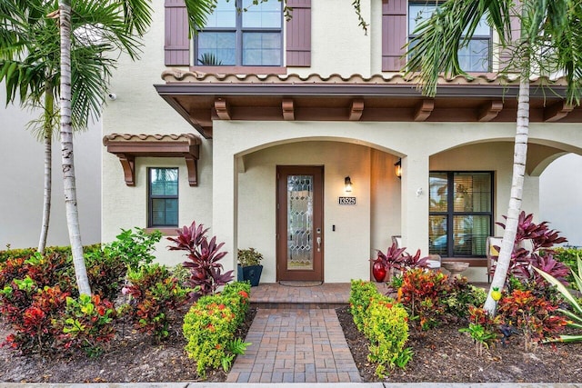 view of exterior entry featuring covered porch