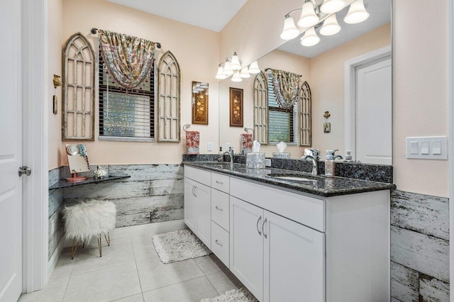 bathroom with vanity, a notable chandelier, and tile patterned flooring