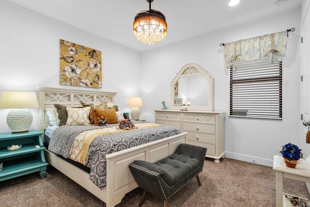 carpeted bedroom featuring a chandelier