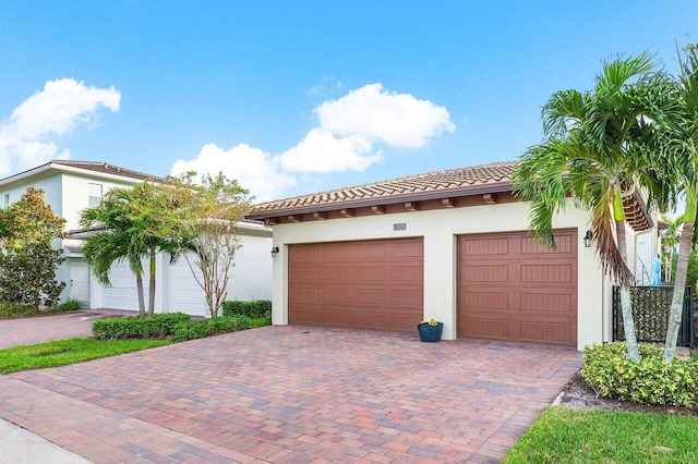 mediterranean / spanish home with a garage