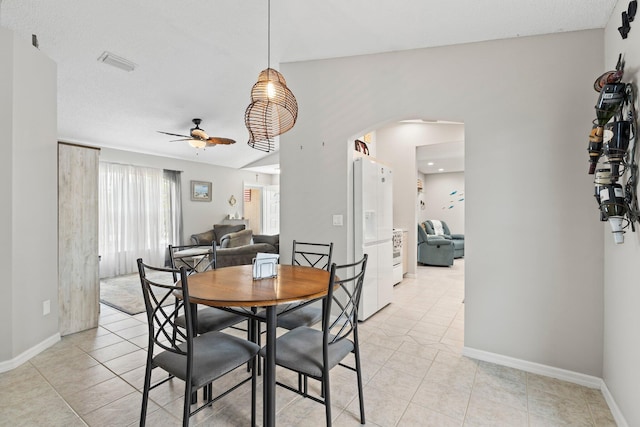 tiled dining room featuring ceiling fan