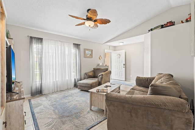 living room featuring a textured ceiling, ceiling fan, light hardwood / wood-style floors, and vaulted ceiling