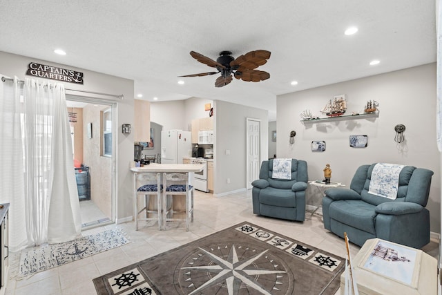 tiled living room featuring a textured ceiling and ceiling fan