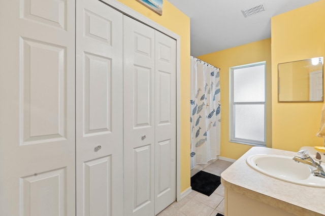 bathroom featuring vanity, tile patterned floors, and curtained shower