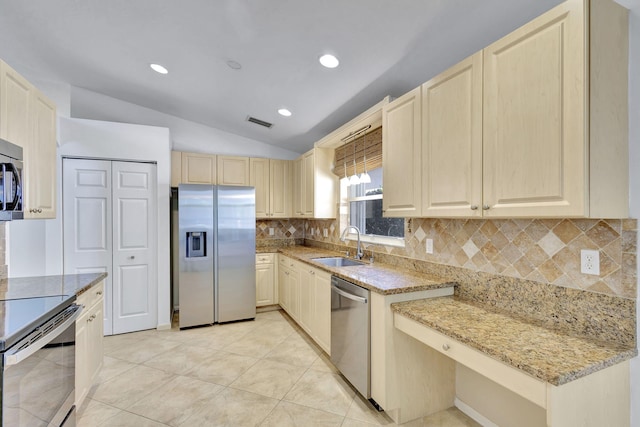 kitchen featuring light stone countertops, backsplash, stainless steel appliances, sink, and lofted ceiling