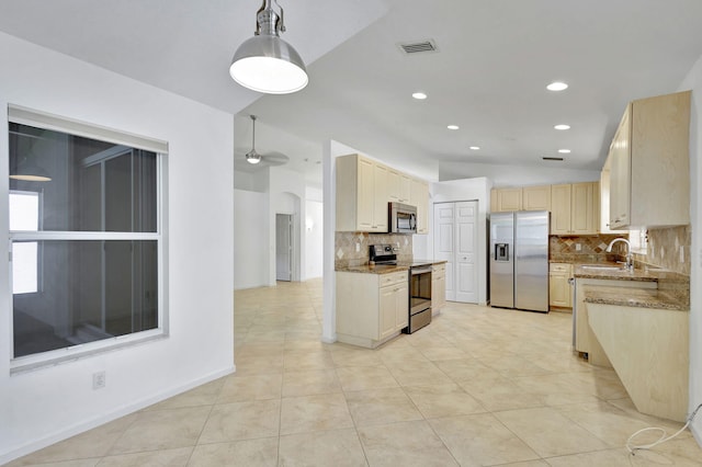 kitchen featuring sink, vaulted ceiling, decorative backsplash, decorative light fixtures, and stainless steel appliances