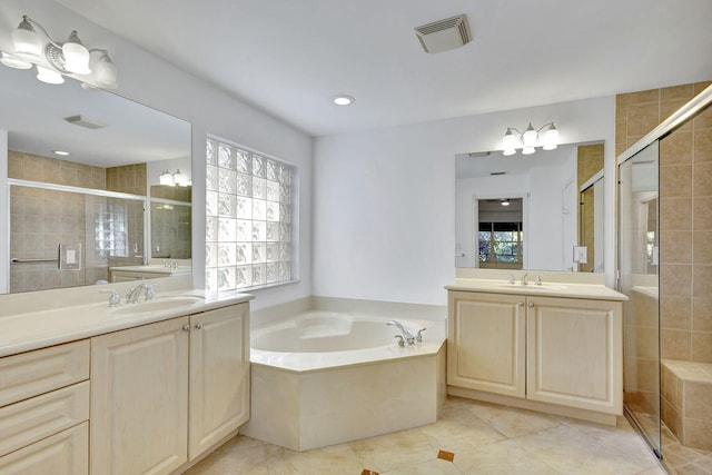 bathroom with tile patterned flooring, vanity, and independent shower and bath