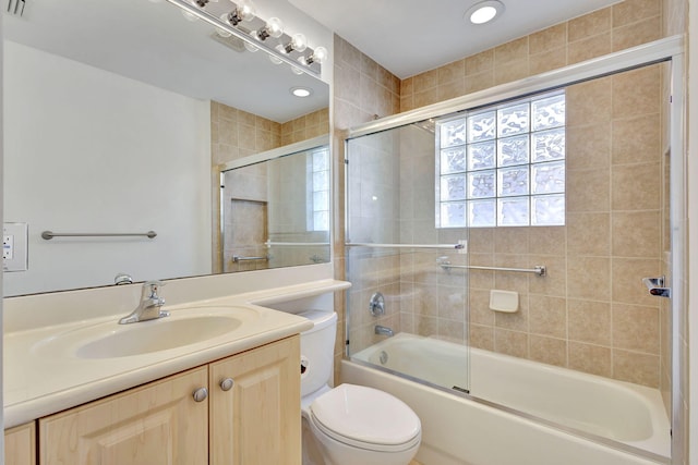 full bathroom featuring vanity, toilet, and bath / shower combo with glass door