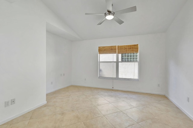 tiled empty room featuring ceiling fan and vaulted ceiling