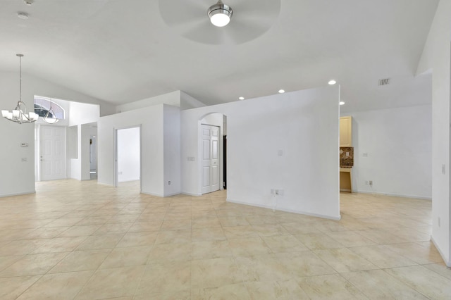 tiled spare room featuring ceiling fan with notable chandelier and lofted ceiling