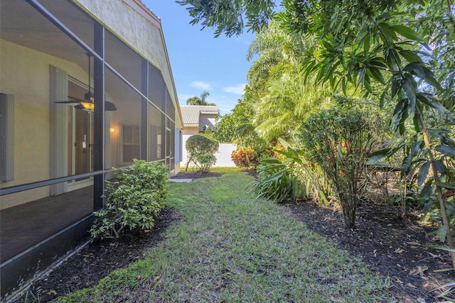 view of yard with glass enclosure