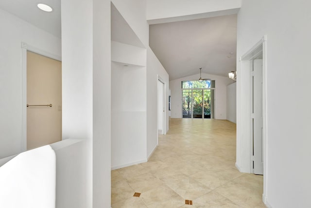 hall featuring vaulted ceiling