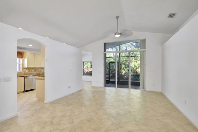 tiled spare room with ceiling fan, plenty of natural light, and lofted ceiling