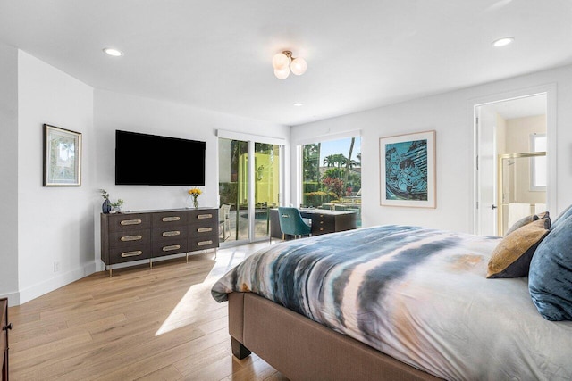 bedroom featuring access to exterior, light hardwood / wood-style floors, and ensuite bath