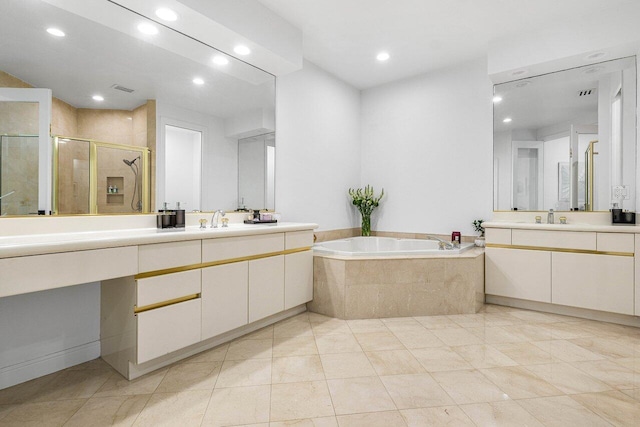 bathroom with tile patterned flooring, vanity, and shower with separate bathtub