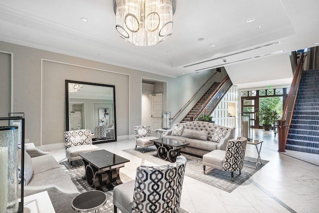 living room with a raised ceiling, crown molding, and a chandelier