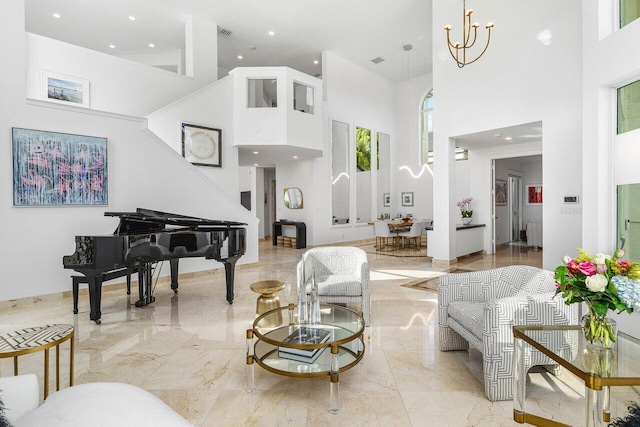 living room featuring a towering ceiling and an inviting chandelier