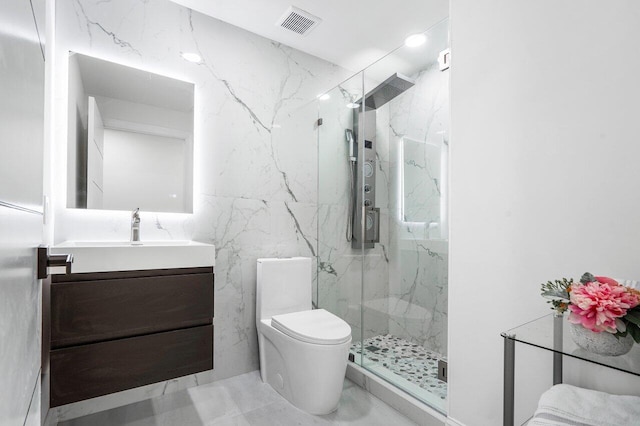 bathroom with vanity, toilet, and a shower with door