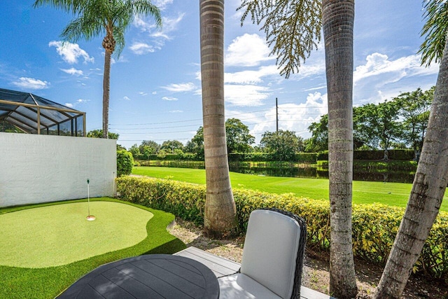 view of yard with a lanai and a water view