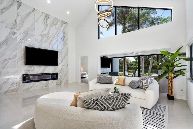 tiled living room with a high end fireplace, a high ceiling, and tile walls