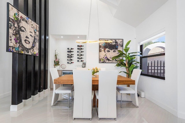 tiled dining space with lofted ceiling