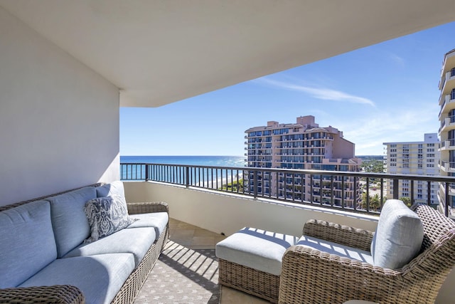 balcony with a water view and an outdoor hangout area