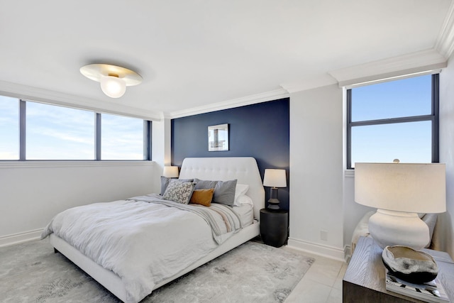 bedroom with light tile patterned floors and crown molding