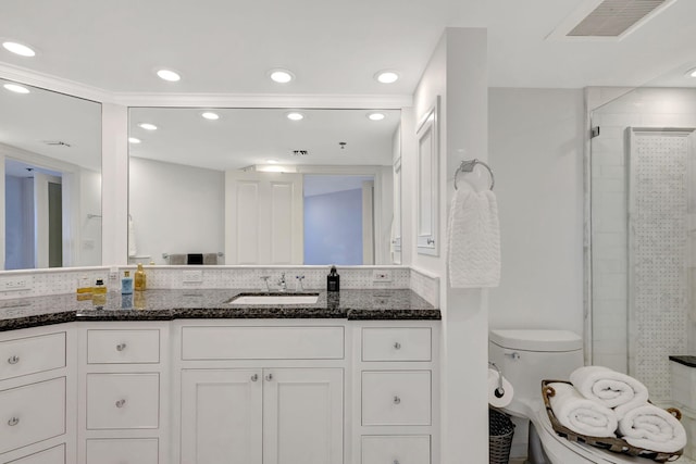 bathroom featuring walk in shower, vanity, and toilet