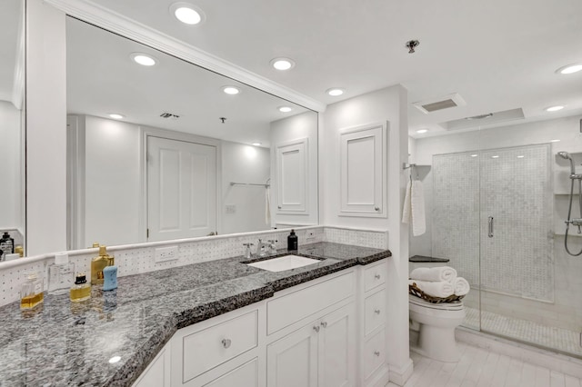 bathroom with tile patterned flooring, vanity, toilet, and a shower with shower door