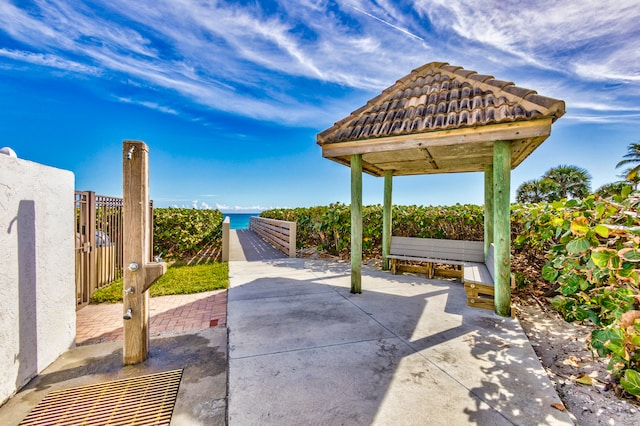 view of patio with a gazebo and a water view