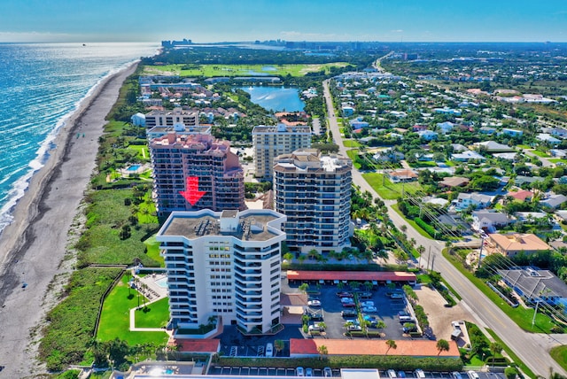 birds eye view of property with a beach view and a water view