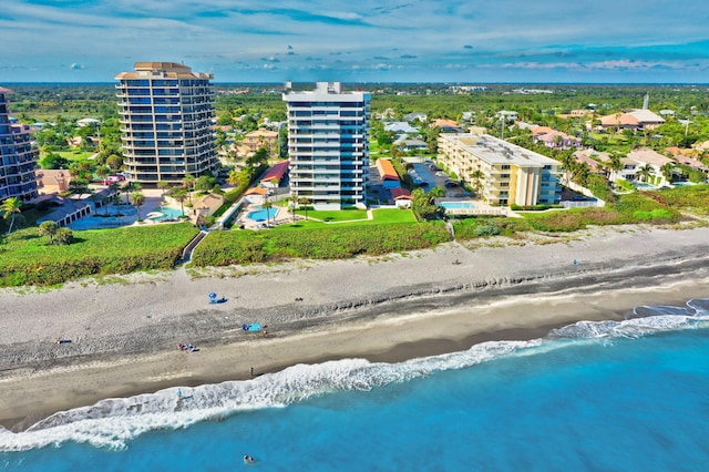 drone / aerial view featuring a water view and a beach view