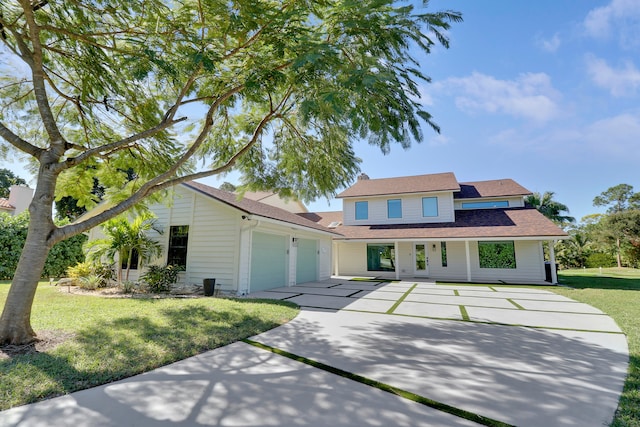 view of front of property with a front yard and a garage