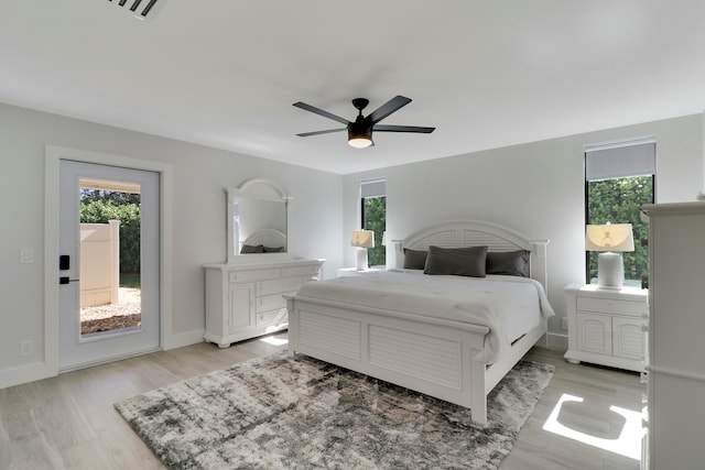 bedroom featuring access to exterior, ceiling fan, and light wood-type flooring